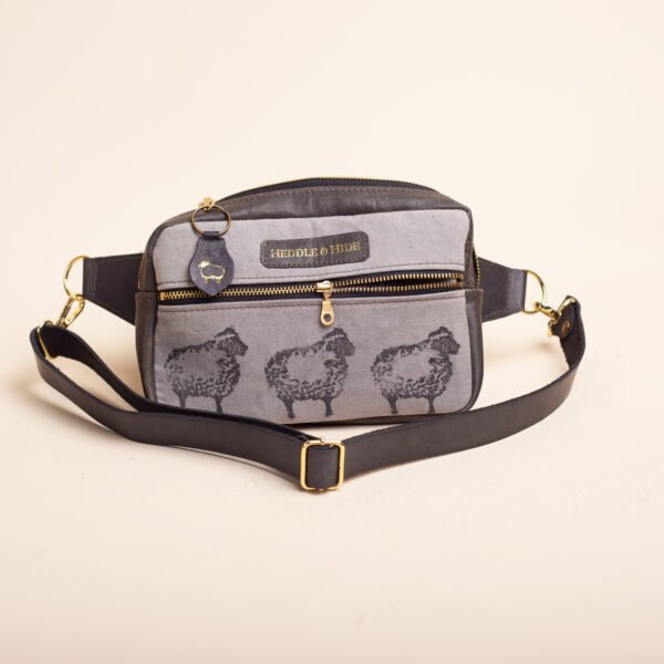 a black leather and canvas fanny pack naturally dyed and printed with black sheep